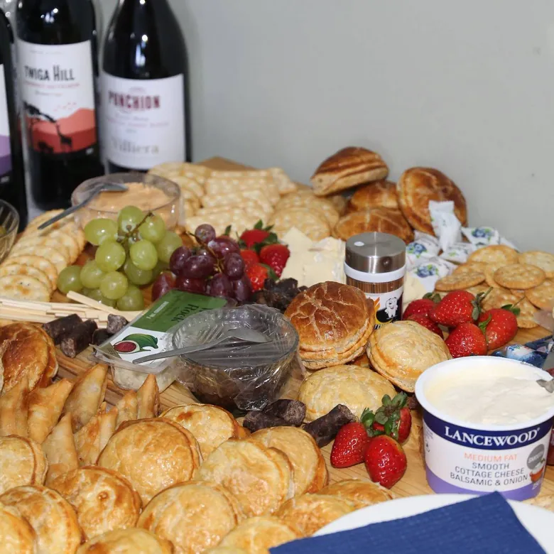 Event grazing table with pastries, fruit, cheese and breads